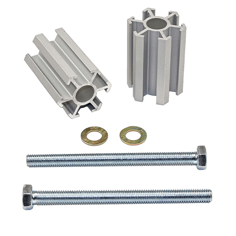 A set of silver-colored aluminum bump stop relocation brackets along with longer bolts for installation.