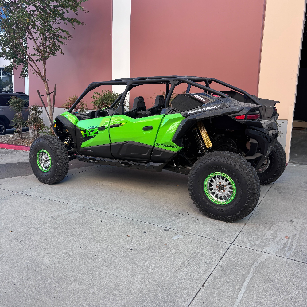 Intake Kit for 2026+ Kawasaki Teryx H2 UTV installed in a green Kawasaki side-by-side vehicle parked on a concrete surface with a building in the background
