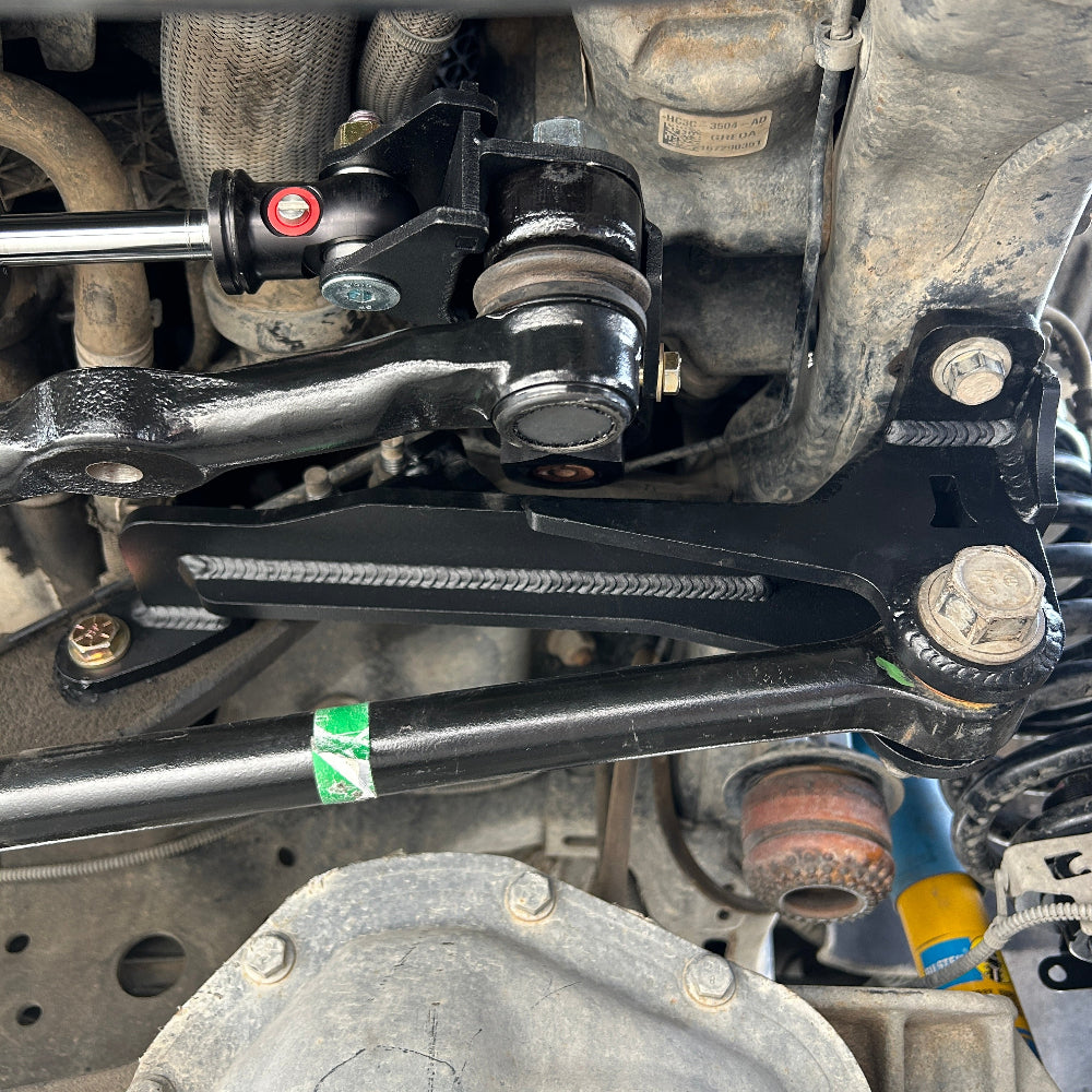 Close-up of a vehicle suspension system with metal components and bolts.