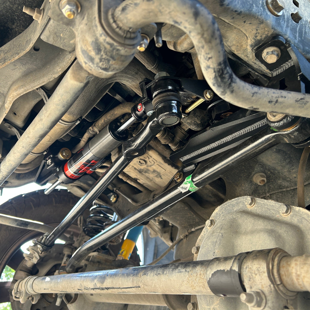Close-up of vehicle suspension system with tools on a clear day