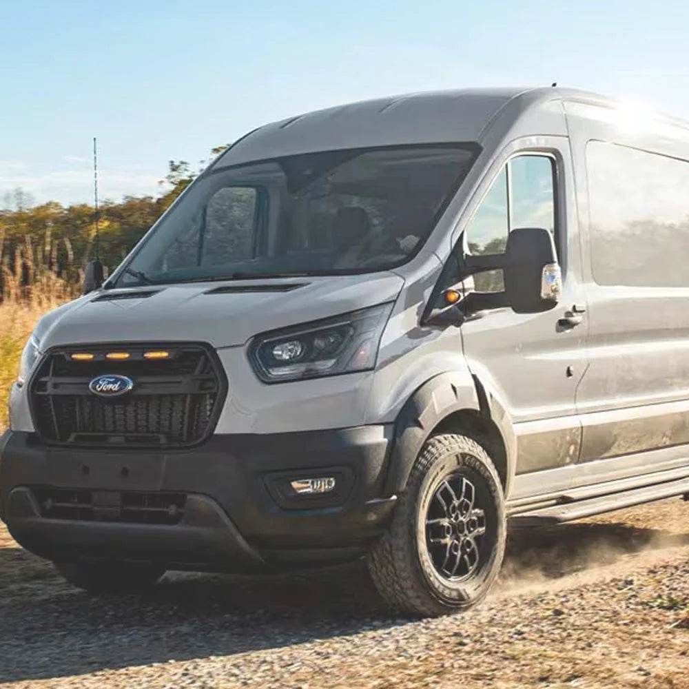 30 Gallon Wheel Well Water Tank (Both Sides) installed in a Ford van driving on a dirt road with a clear sky in the background