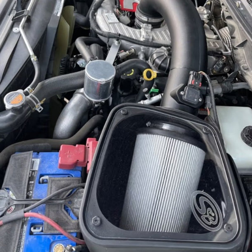 Cold Air Intake for 2016-2019 Nissan Titan XD 5.0L Cummins Diesel on a white background installed in the engine compartment of a vehicle.
