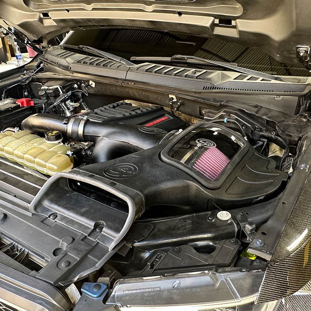 Cold Air Intake for 2018-2025 Ford F-150 2.7L, 3.5L Ecoboost, Raptor on a white background installed in the engine compartment of a vehicle.
