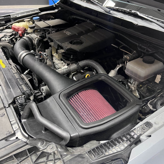 
  Cold Air Intake For 2005-2019 Nissan Frontier, 2005-2012 Pathfinder, 2005-2015 Xterra 4.0L - S&B installed in the engine compartment of a vehicle

