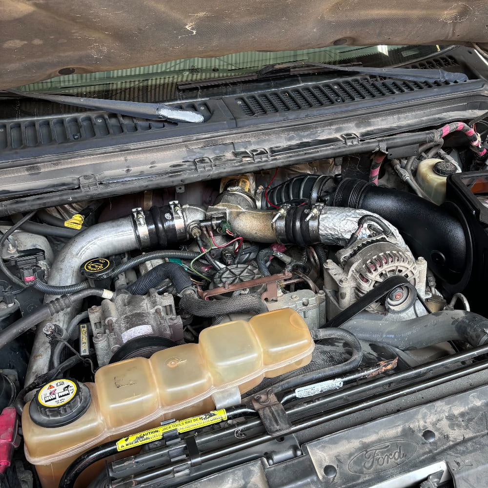 Car engine compartment with an S&B Hot and Cold Side Boot Kit for 1999.5-2003 Ford F250/F350, 7.3L Powerstroke