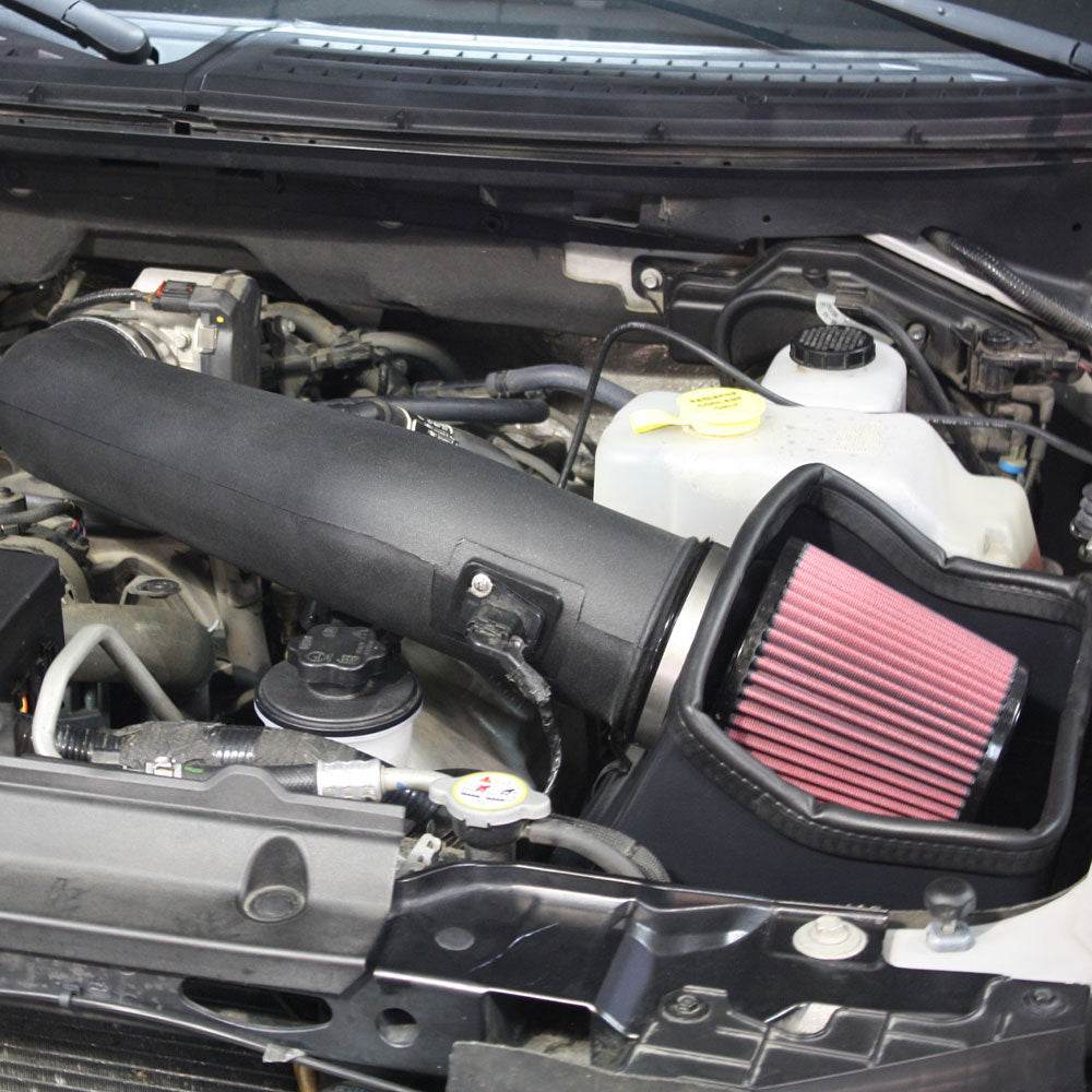 Close up of a JLT Cold Air Intake for 2010-2014 F-150/Raptor 6.2L - S&B installed in the engine compartment of a vehicle
