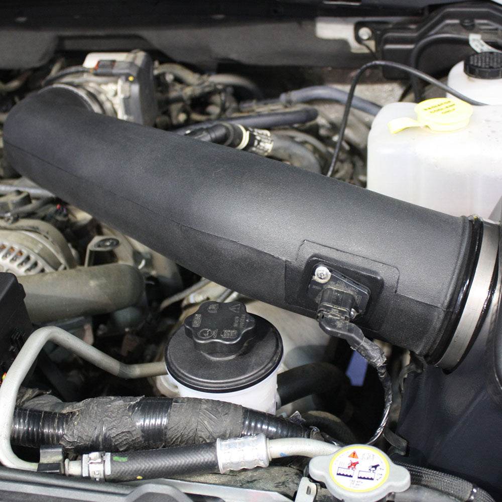 Close up of a JLT Cold Air Intake for 2010-2014 F-150/Raptor 6.2L - S&B installed in the engine compartment of a vehicle
