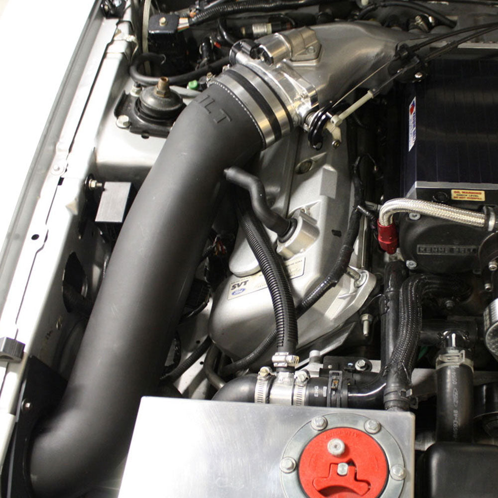 A JLT 12" High Boost Cold Air Intake for 2003-2004 SVT Cobra installed in the engine compartment of a vehicle.