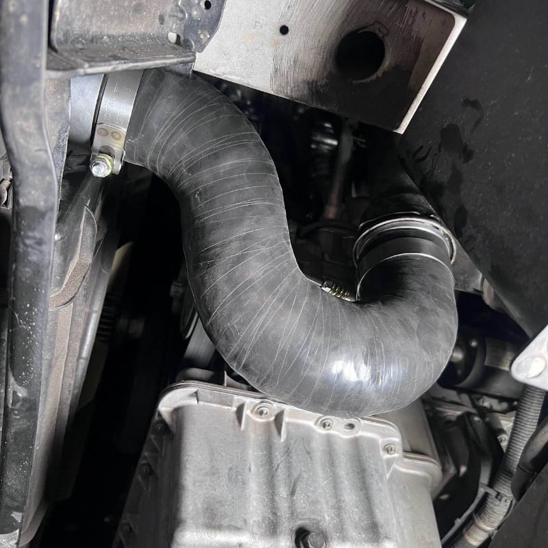 Close-up of an SB Filters Cold Side Intercooler Pipe for 2019-2022 Mercedes Sprinter 3.0L Diesel  and metal components.