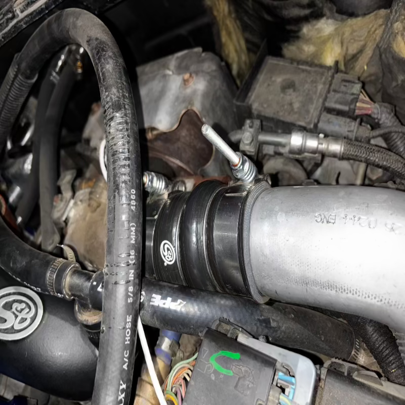 Close-up of an SB Filters Hot and Cold Side Boot Kit For 2004.5-2005 Chevy / GMC Duramax 6.6L (LLY) with visible hoses and metal parts.