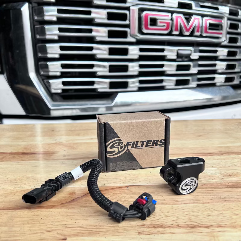 SB Map sensor spacer and its packaging in front of a GMC vehicle grille.