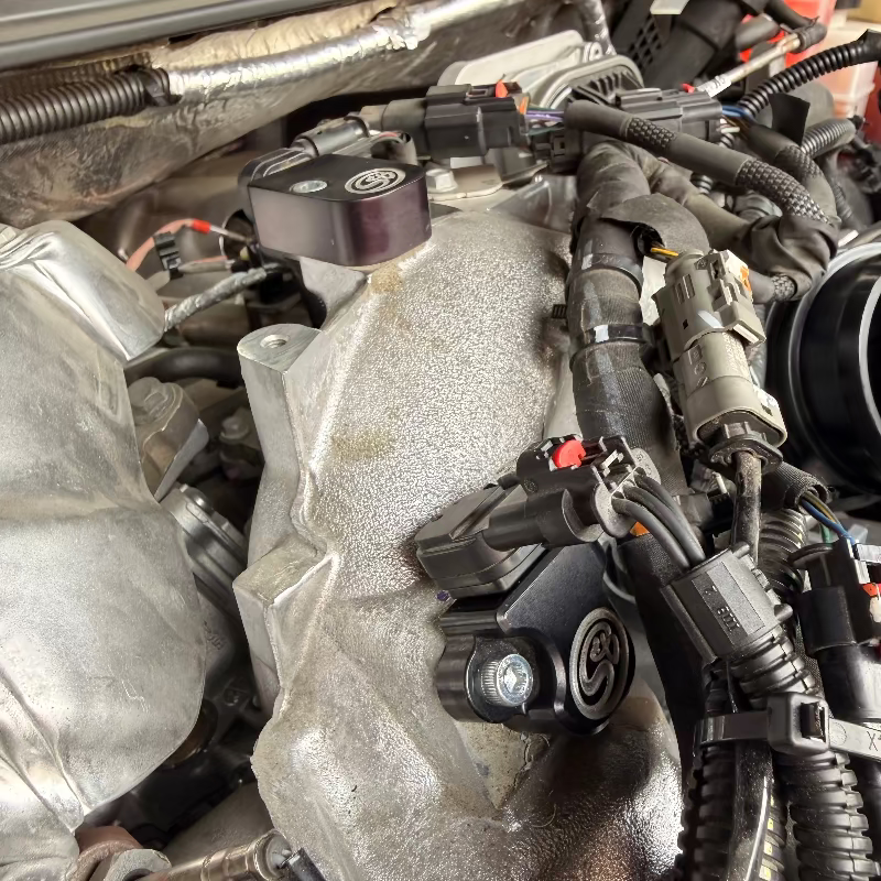 Close-up of a car engine with an SB Map sensor spacer installed