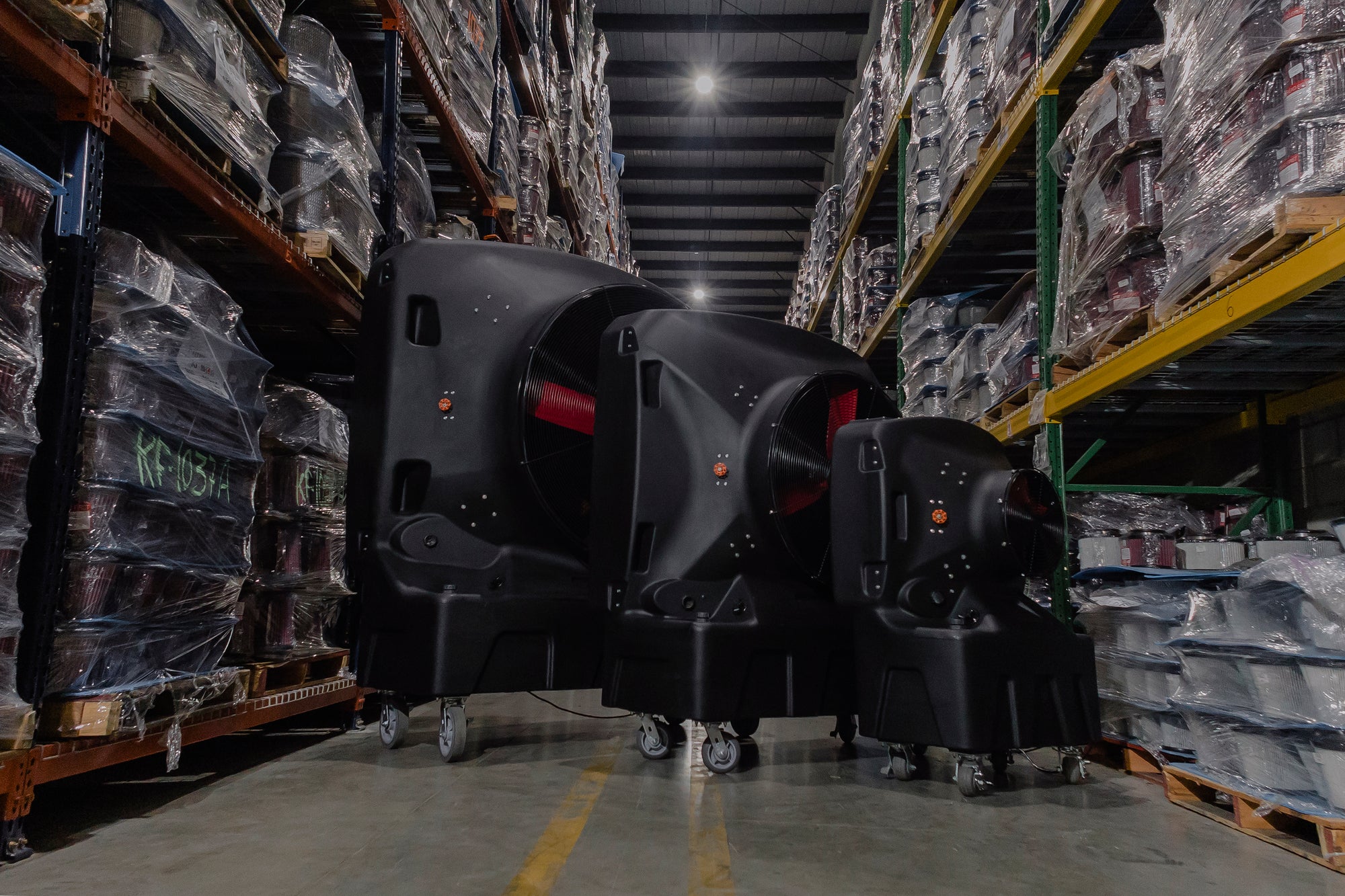large, medium and small evaporative cooler in a warehouse