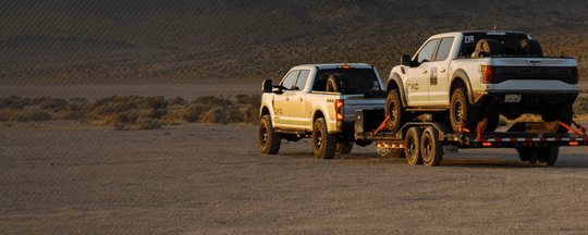 
  Two trucks in a desert
