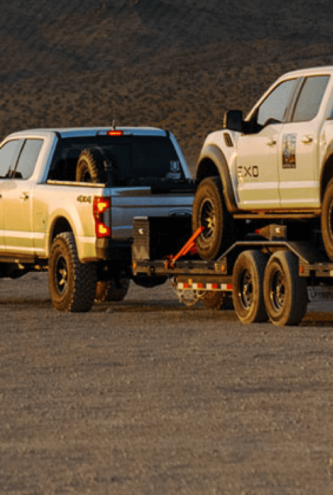 
  Two trucks in a desert mobile banner

